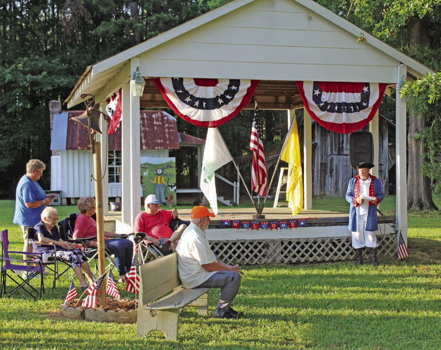 Rick Beckner of New Edinburg (right), dressed in a replica Continental Army costume, started the festivities by reciting the events and circumstances surrounding the foundation of the United States in 1776. 
