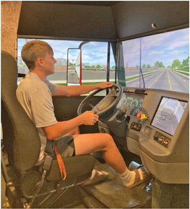 Woodlawn junior Garrett Weatherford tries his hand at driving a big rig in the semi simulator.