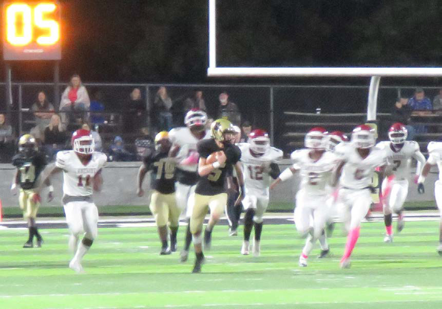 OFF TO THE RACES - Rison quarterback Blaine Dixon busts through the line of scrimmage on his way to a 64-yard touchdown run late in the fourth quarter to help put away the scrappy Lake Village Beavers. Dixon had an outstanding night in all three phases of the game. On offense, he rushed for 163 yards, the most by a Wildcat quarterback in more than 50 years, while completing his only pass of the game for an 83-yard touchdown.On special teams, he blocked a point-after attempt while successfully kicking three 