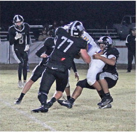 BIG STOP FOR BEARS - After Spring Hill had scored on three cons ecutive possession in the first half, Goodlawn's Ryan Rauls (right) stopped Spring Hill's big All-State running back Terry Tipton for no gain on first down, eventually forcing a three-and-out. Goodlawn Coach Zach Meyer said it took them more than a quarter to figure out a better way to defend against a new wrinkle that Spring Hill had installed with its triple option. Closing in to assist on the tackle is Goodlawn's Brayden Kitchens (no. 77) ,
