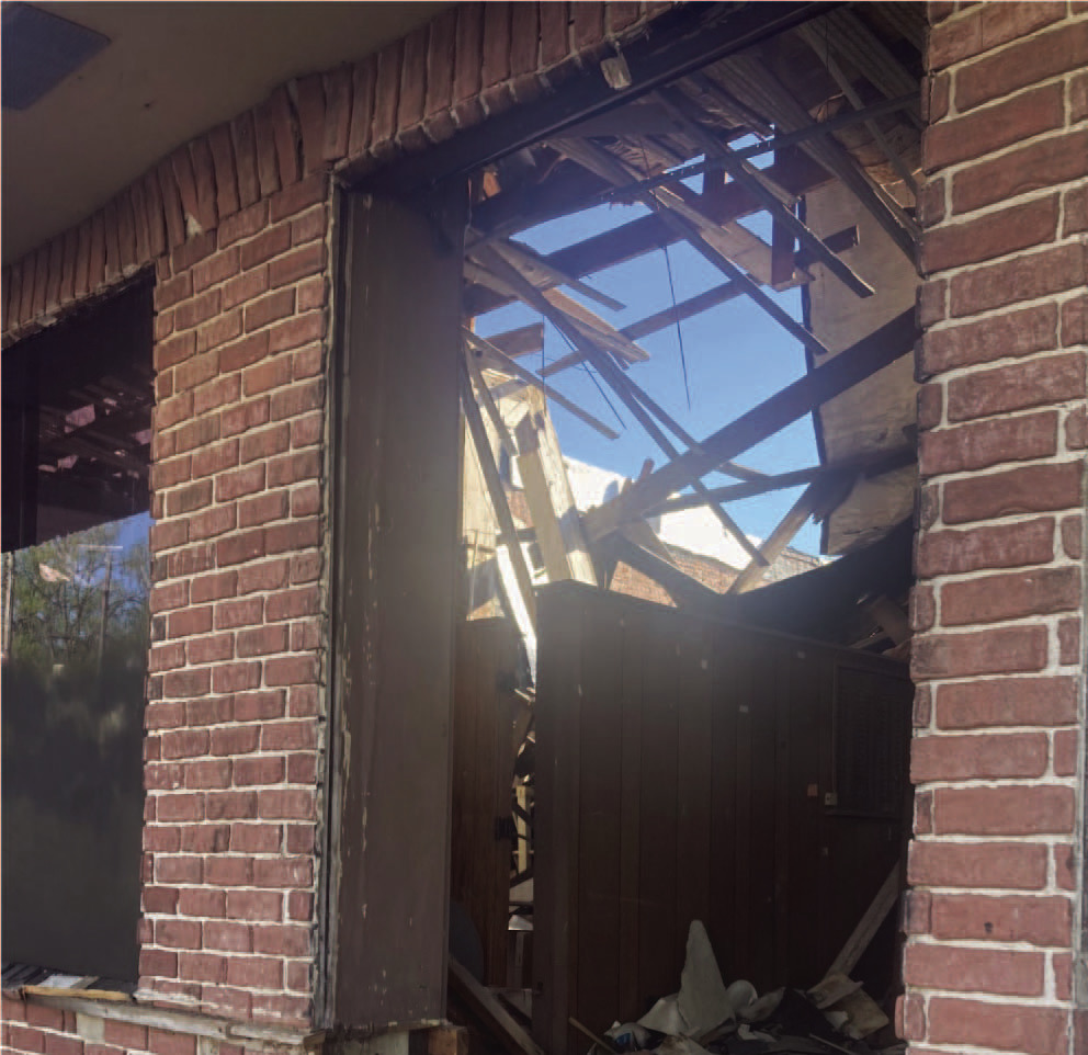 DOWNTOWN BUILDINGS - While the clean-up of residential properti es will be a major focus for Mayor Charles Roberts, he also said he intends to address some of the buildings in the downtown area. This photo taken of a broken front window of the old Cash Grocery building on Main Street in downtown Rison reveals that the roof has collapses the entire length of the structure. Roberts said he intends to discuss the Cash building during the next city council meeting.