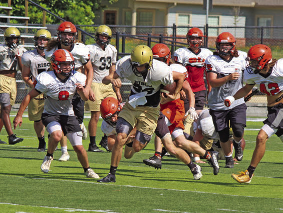 MORRISON ON THE RUN - Rison quarterback Owen Morrison shakes off a Magnet Cove defender during last Thursday’s team camp at George Walker Field of Champions. Wildcat Coach Caleb Carmikle said Morrison has picked up the run-pass option well, and will give opposing defenses something else to think up in the upcoming season. Carmikle said Morrison has deceptive speed for his size.