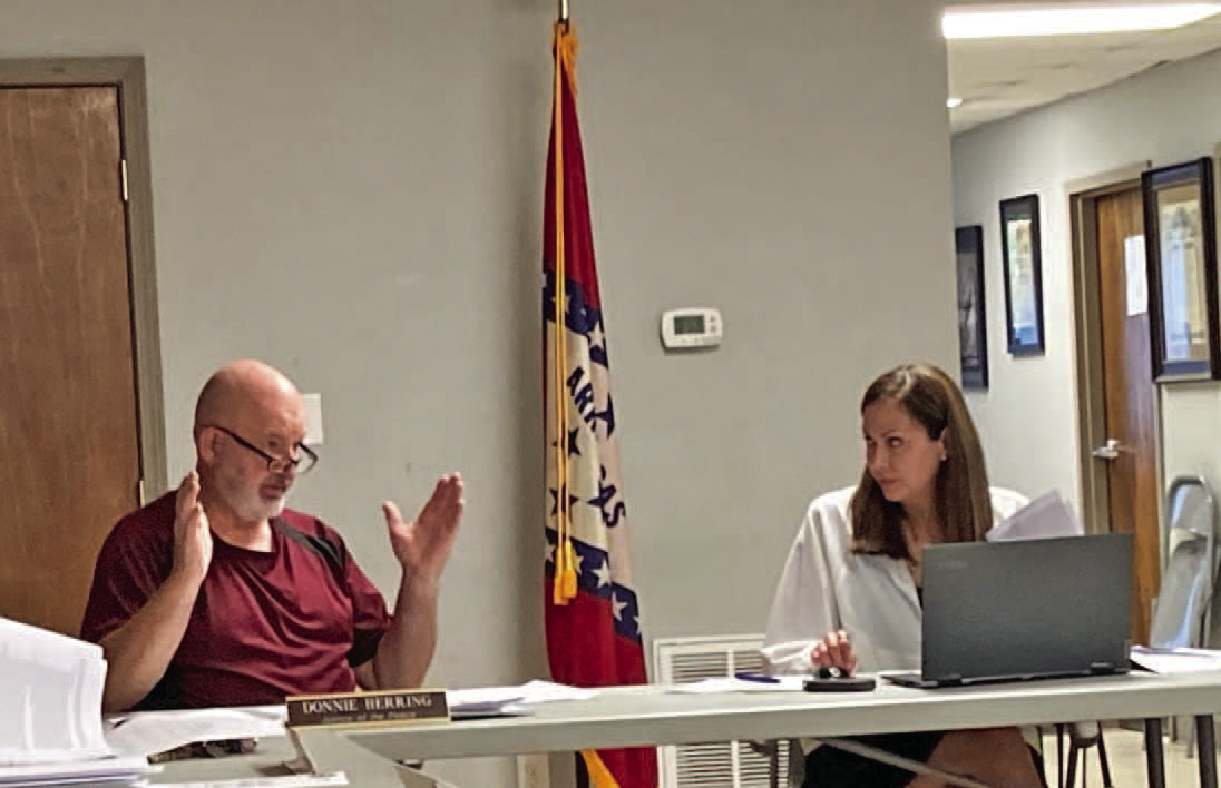 DATA MINING DISCUSSION - Justice of the Peace Donnie Herring (left) of talks to County Attorney Tiffany Nutt about some of the issues surrounding an ordinance that establishes building guidelines for data mining centers in Cleveland County. Herring, along with Justice Charles Rodgers of Rison, were both critical of the centers. Herring cited the fact that the centers are a tremendous drain on a community's electrical infrastructure and the centers do not provide any tax or employment benefits.