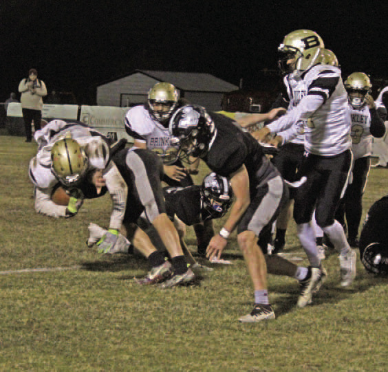 WOODLAWN 60, BRINKLEY 16 - Woodlawn's Landen Booth (left) brings Brinkley's Jeremiah Harris as he meets the 6-4, 220-pound quarterback at the line of scrimmage during first half action of the Bears' 60-14 win in the first round of the Class 2A eight-man state playoffs at the Carl Jones Sports Complex. Woodlawn travels to Izard County Friday night for a chance to arn a spot in the Dec. 1 state championship game at War Memorial Stadium in Little Rock. (See story page 9)