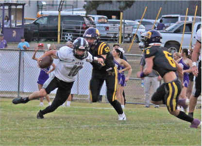 BREAKOUT GAME FOR MOORE - Woodlawn junior quarterback/running b ack Aden Moore (no. 10) left elude the tackle of Praire View's Will Waggoner (no. 51) and Hayden Little (no. 6). Moore, who saw limited action as last year's back-up quarter, had a breakout game as he rushed for 106 yards with an 83-yard touchdown run and completing a 52-yard touchdown pass to Ethan Adair. Moore played both quarterback and I back in the game.