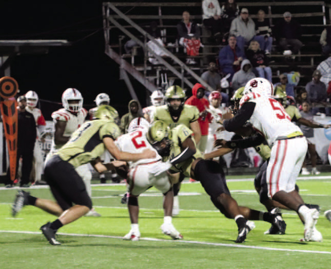 TAKING DOWN A PIRATE - Rison’s Jaquis Rauls (center, no. 6) makes contact with the Drew Central quarterback before teammate Eli Turner (left, no. 33) comes in to assist on the 14-yard sack on fourth-and-seven in the second quarter. The Wildcats drove the 56 yards in 16 plays to take a 27-13 lead into halftime. Rauls had a huge game defensively, recording nine tackles, five solo tackles and one turnover.