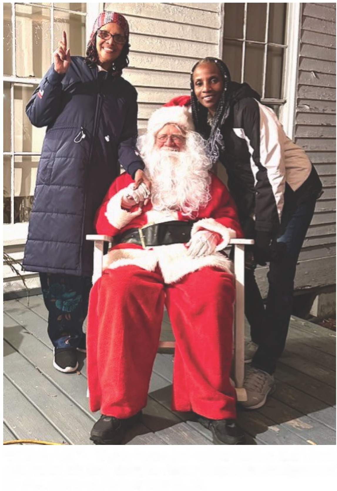 VISITING SANTA - Virginia Brewer (left) and her daughter Sheila Smith (right) visited with Santa during the Pioneer Village's drive-thru lights event this past Friday night. Photo by Marty Bowlin.