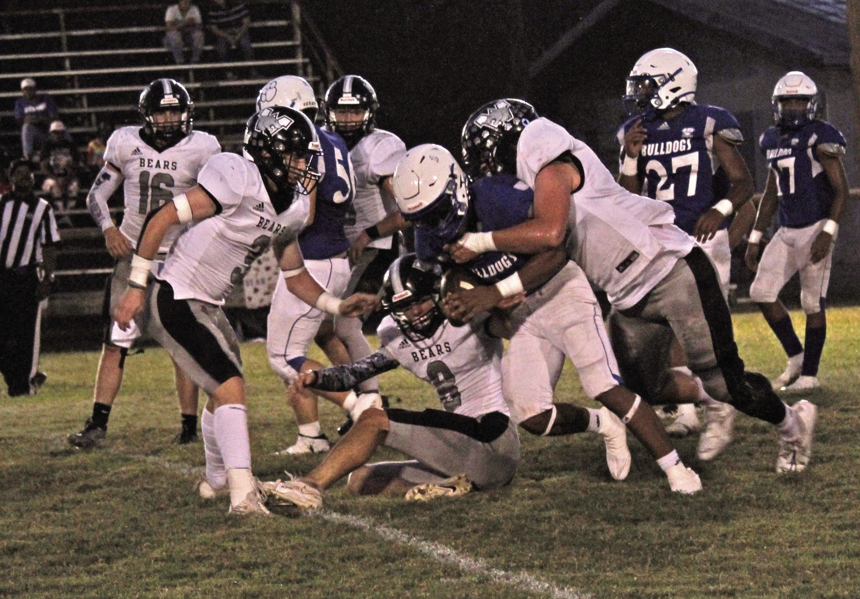BRINGING DOWN A BULLDOG - Woodlawn’s Brayden Kitchens (right) brings down Strong’s Germyren McHenry after the Bears’ Aidan Johnson (no. 8, center) corralled McHenry by his shirt. The Bulldogs used their speed advantage throughout the game to test the Bears’ defense, both on the ground and through the air. Also pictured for Woodlawn are Ethan Oliver (no. 16) and Garrett Weatherford (no. 3).