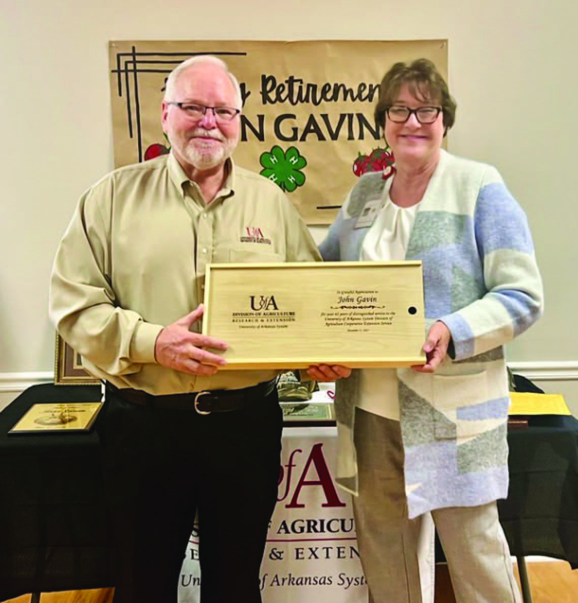 JOHN GAVIN RETIRING AFTER 42 YEARS OF SERVICE - Arkansas Cooperative Extension Service Ouachita District Director Carla Due (left) presents Bradley County Ag Extension Agent John Gavin (right) a barbeque grilling set during Gavin's retirement party on Dec. 17 in Warren. (Photo compliments of University of Arkansas Division of Agriculture)