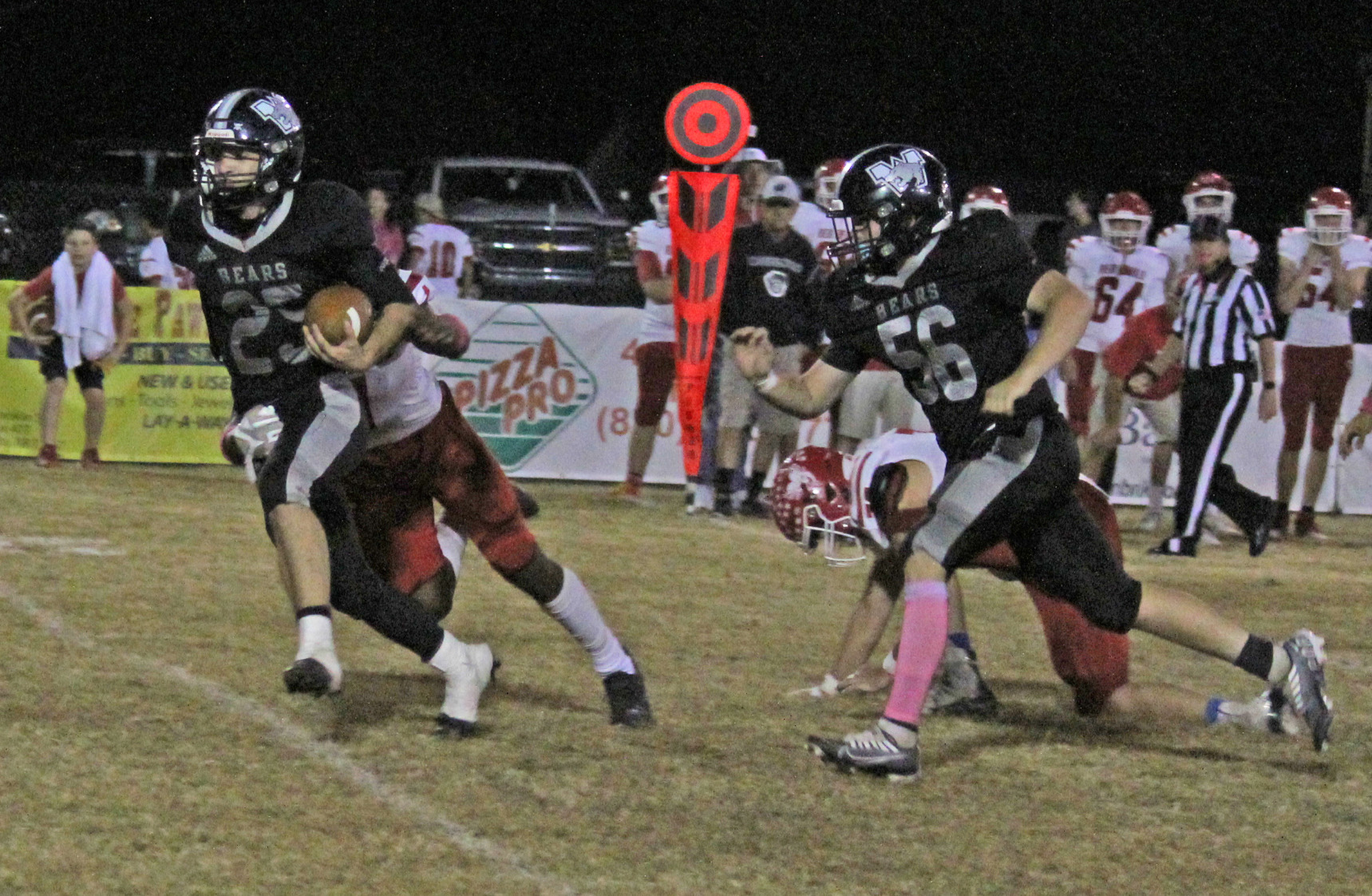 HALE TURNS IN BIG GAME - Woodlawn senior Fisher Hale (left, no. 25) picks up a first down for the Bears during first half action Friday night in Woodlawn’s showdown with top-ranked Mountain Pine. Hale, a two-way starter, had one of his best overall performances of his career, rushing for a team-high 112 yards on 13 carries with a touchdown, and recording 10 tackles and an interception from his linebacker position on defense. Trailing on the play for the Bears is lineman Steven Adair.