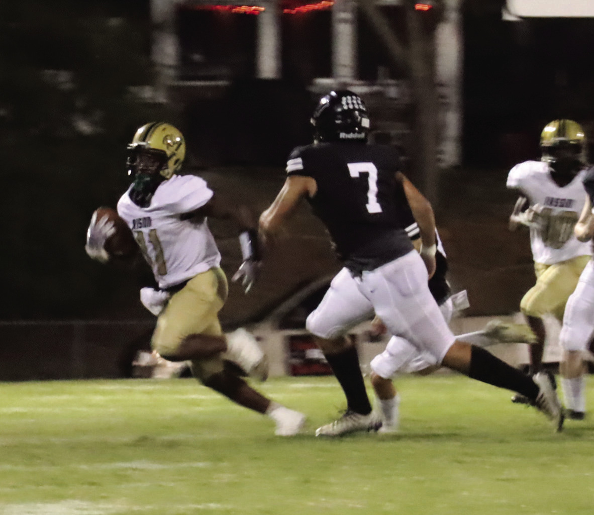 WALKER GETS RISON ON THE BOARD - Rison's Za'Kyler Walker (left, no. 11) eludes the tackle of Bigelow's Keithlin Brown (no. 7) on his way to a 67-yard punt return for a touchdown in the second to give the Wildcats' their first score of the game. Walker had 208 all-purpose yards for the night. (Photo by Chris Phillips)