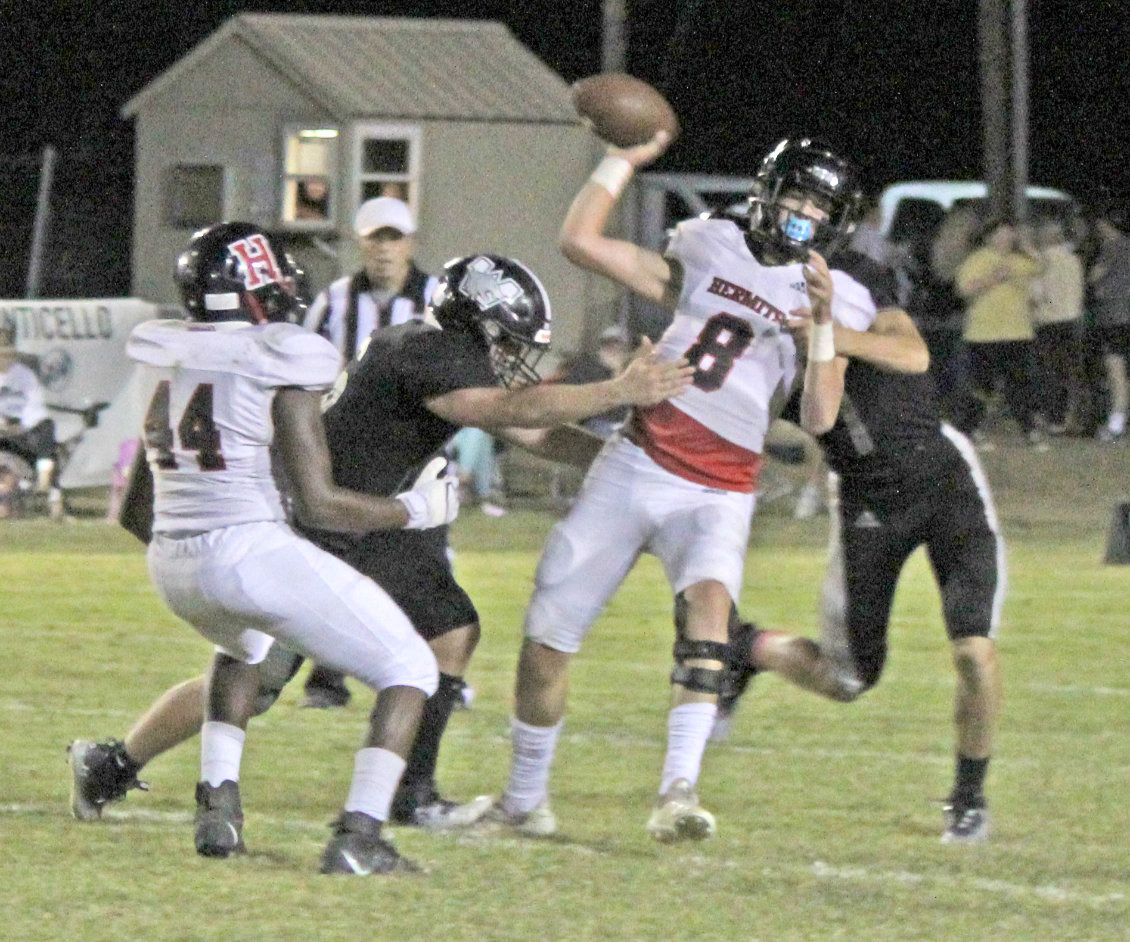 BRINGING HEAT TO THE HERMITS - Woodlawn sophomore Ethan Oliver (left) and senior Jais King (right) bring pressure to Hermitage quarterback J.T. Best (center, no. 8) during the Bears’ 57-0 shutout of the Hermits last Friday night. While Oliver has been a regular contributor on defense, Woodlawn Coach Zach Meyer pointed out that Oliver also earned his first start at offensive guard after a good week of practice.