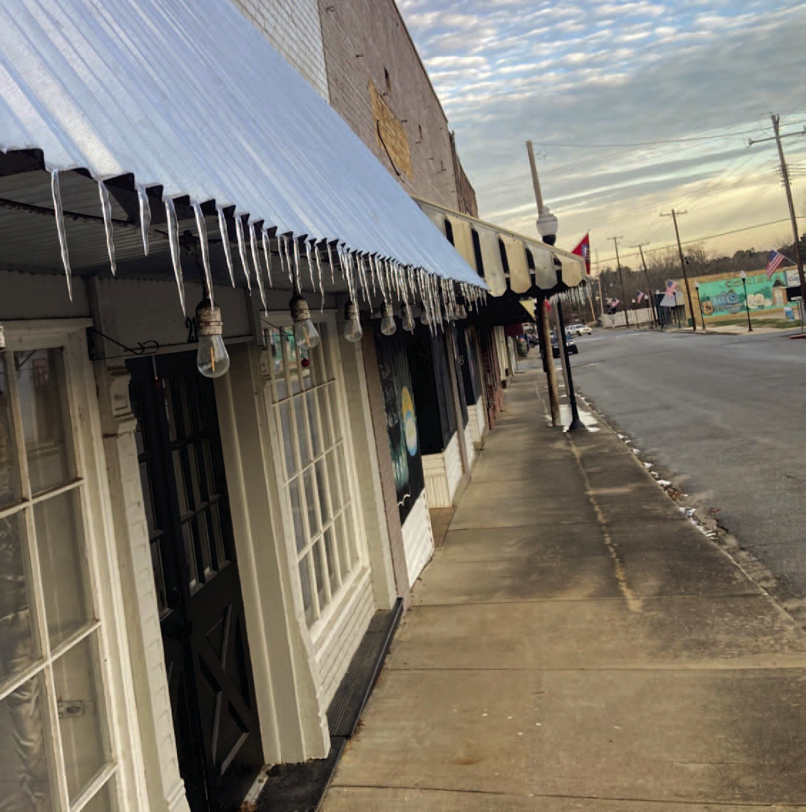 DISTANT MEMORY NOW - Icicles dangle from the edge of awnings in the downtown area of Rison last Thursday and Friday after Cleveland County was hit with a polar cold front last week. A round of light freezing rain, sleet and snow fell from Tuesday evening through Wednesday morning, coating roadways and roof tops in ice. After the sun came out Wednesday afternoon, much of that frozen precipitation melted and froze again overnight to form the icicles. Temperatures bounced back into the 70s by Tuesday.