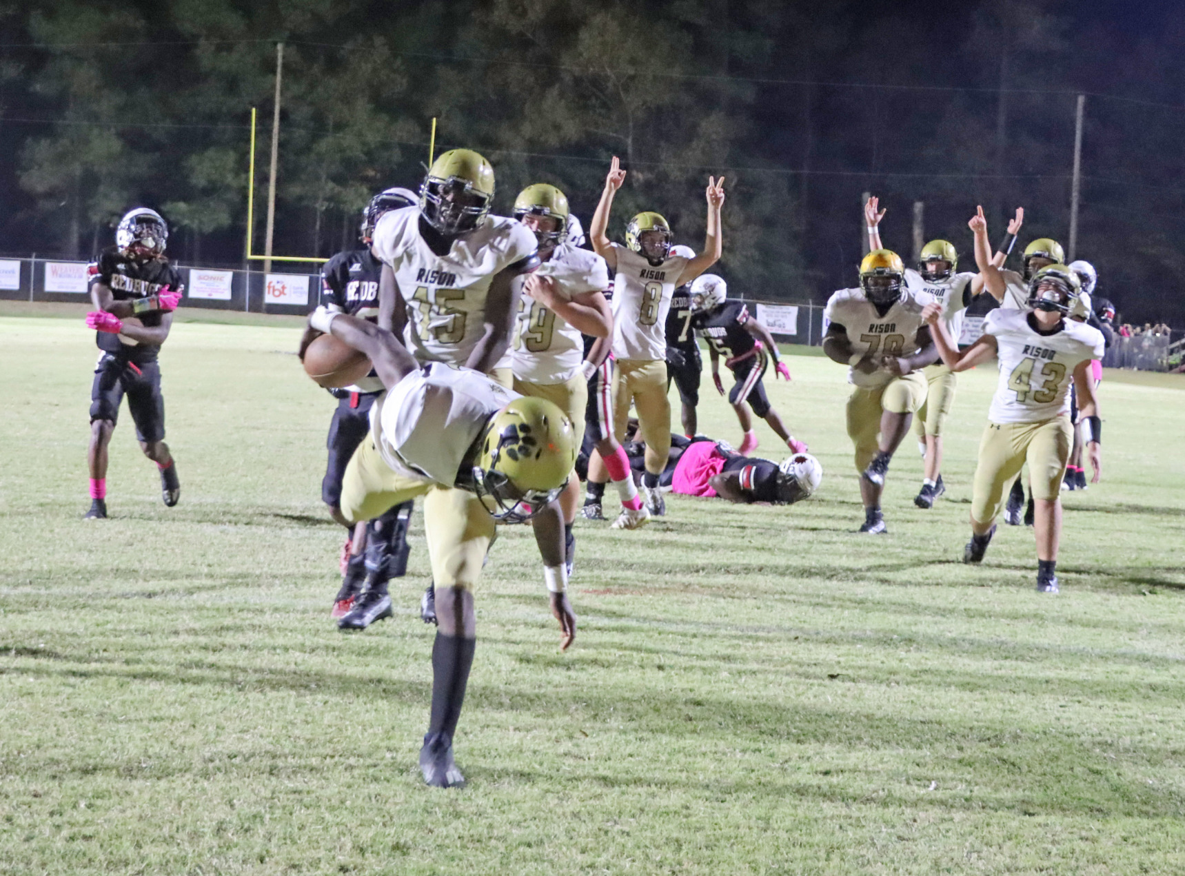 WAINWRIGHT PUTS RISON BACK ON TOP - With his teammates already celebrating in the background, Rison’s Treyvion Wainwright (foreground) lunges across the goal line to put the Wildcats back on top, 24-16, with 4:41 left in game. Wainwright had an outstanding game overall, recording six tackles and five pass break-ups on defense and then intercepting and returning a lateral on Fordyce’s last-ditch kickoff return for a touchdown. (Photo by Chris Phillips)