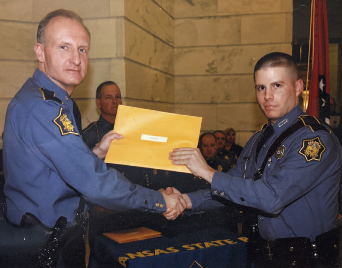 Brad Young (right) early in his career with the Arkansas State Police