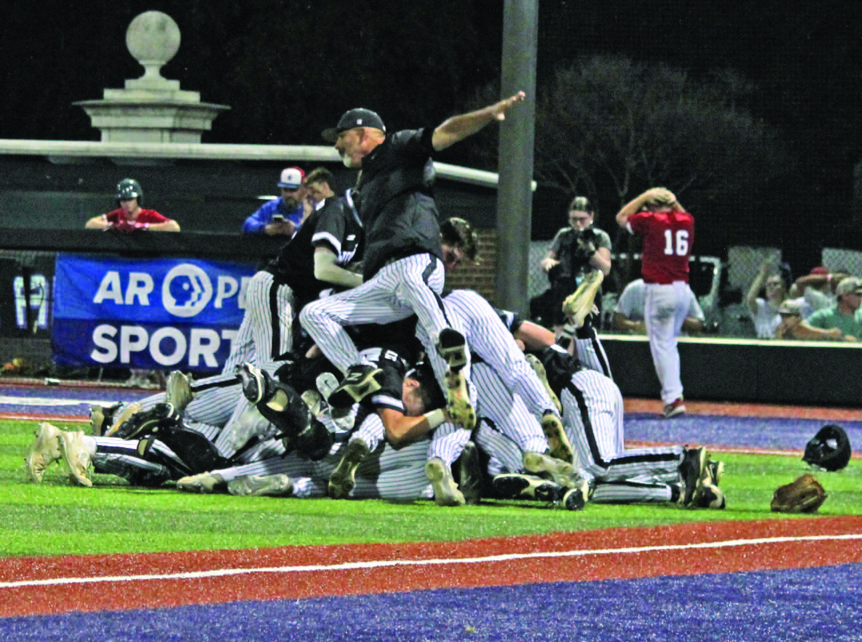 Woodlawn Coach Tommy Richardson backs onto the dogpile following the Bears' 3-2 nail-biting victory over the Palestine-Wheatley Patriots last Friday night at the University of Central Arkansas in Conway. Richardson has guided Woodlawn to 12 appearances in the state championship game, winning nine of those.