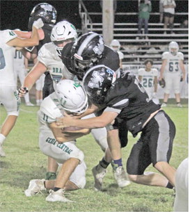 STEVEN ADAIR HAS BIG GAME - Woodlawn linebacker Steven Adair (right, no. 56) closes in with fellow senior Daxton White (middle) to bring down Genoa Central's Caleb McClure. Bears defensive coordinator Alan Neill named Adair his "Defensive Player of the Week" have recording 12 tackles against the Dragons, three for losses.