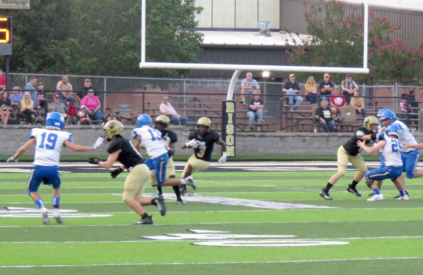 BIG HOLE FOR WALKER - Rison junior kick returner ZaKyler Waker (center, no. 3) finds a huge hole in the middle of the field as he turns upfield on his way to a 96-yard touchdown return on the opening kickoff of the Wildcats’ nonconference game with the Bismarck Lions Friday night at George Walker Field of Champions. Setting up the blocks for the big kickoff return are Rison teammates Ryan Hyatt (left), DJ Kings (second from left) and James Mitchell (right). (Photo by Michelle Rawls)