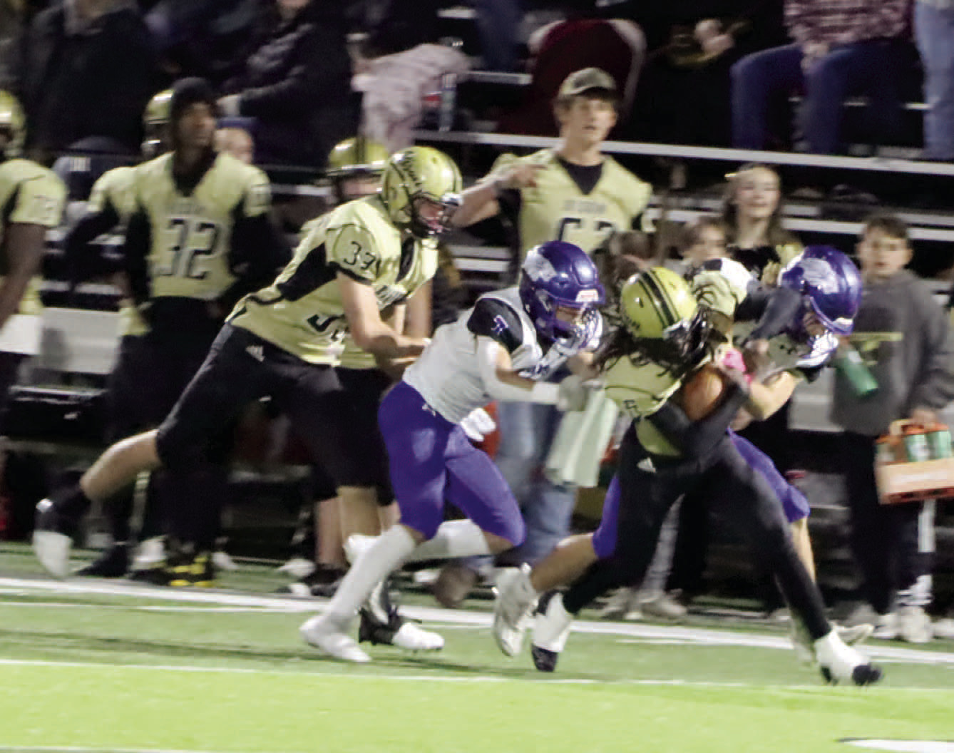 NO EASY YARDS - Rison's Jeramiah Marshall tries to shake off a couple of Jessieville defenders near midfield during second half action of last Friday's first round playoff game at George Walker Field of Champions. Rison finished the game with 147 yards rushing on 38 attempts to average 3.8 yards per run. Trailing on the play for the Wildcats is Eli Turner (no. 33) who caught a touchdown pass in the closing minutes for Rison's final score of the game. (Photo by Chris Phillips)