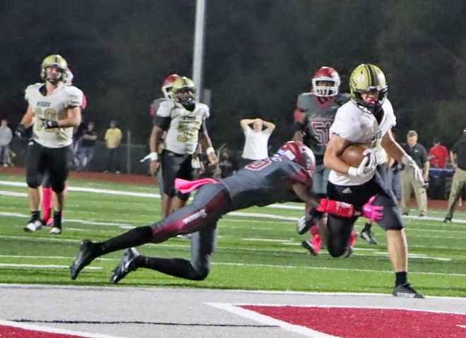 INVOKING THE MERCY CLOCK - Rison’s Eli Turner eludes the tackle of a Lake Village defender to cross into the end zone to push the Wildcats’ lead to 35-0 with 8:53 left in the game to invoke the running clock for the rest of the contest. (Photo by Chris Phillips)
