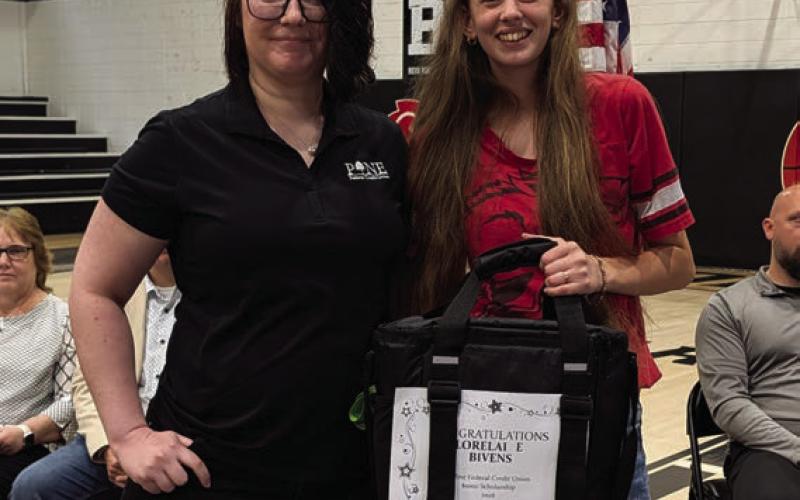Rachel Hulett presents the Pine Federal Credit Union Scholarship to Lorelai Bivens