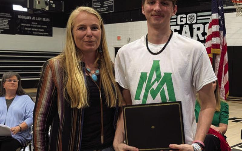 Hallie Mull presents the Cleveland County Cattleman’s Association Scholarship to Jack Lephiew