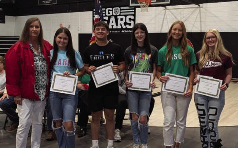 Jenny Wright (far left) presents the Dakota Wright Memorial Scholarship to Baylee Aud, Tyner Burris, Kate Morrison, Kennedy Smith and Cheyanne Zorn