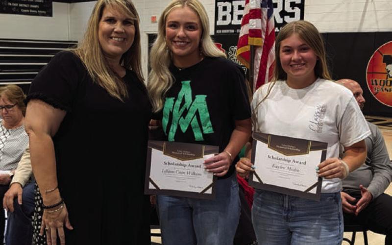 Misty Davis presents the Tylor Holmes Memorial Scholarship to Cain Wilkins and Kaylee Misho