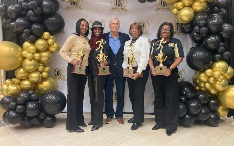 1980 ONE-MILE RELAY TEAM - Members of the record-setting one-mile relay team were (left to right) Patricia Johnson Bell, Sheila Smith Whittington, Coach Howard Honnell, Stephanie Barnett White, and Willie Bea Williams Brandon.