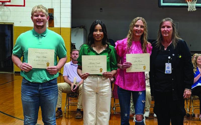 Jenny Wright (far right) presents the Dakota Wright Memorial Scholarship to Bryce Phillips, Marcela Castillo and Josie Farrer
