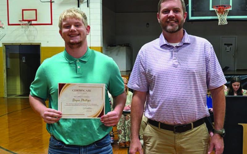 Shane Davis presents the Cleveland County Farm Bureau Scholarship to Bryce Phillips