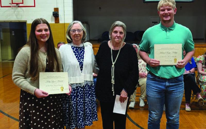 Mary Ann Franklin and Deborah Brucks present the Roy Sturgis Memorial Scholarship to Addy Mitchell (far left) and the Callie Weems Memorial Scholarship to Bryce Phillips (far right)