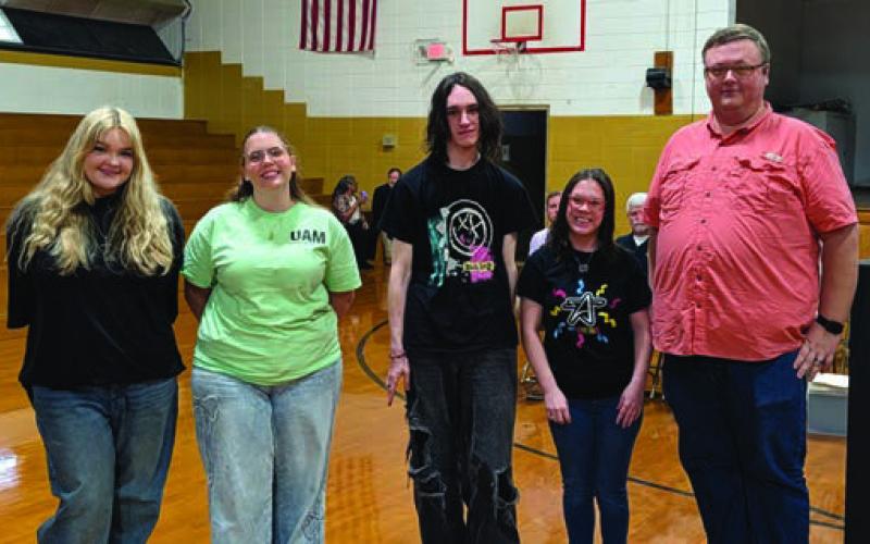 John Kloap (far right) presents the RHS Band Booster Scholarships to Lucille Rhodes, Julie Reeves, James Drye and Natalie Spears.