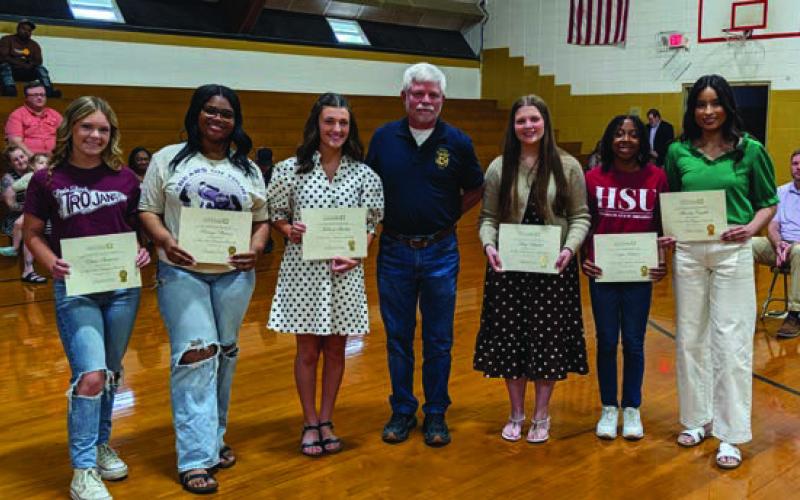 Jeff Wilson (center) presents the RHS 1950 State Championship Scholarship to Elissa Summar, Brinya Watson, Mallory Stuckey, Addy Mitchell, Kayla Jackson and Marcela Castillo