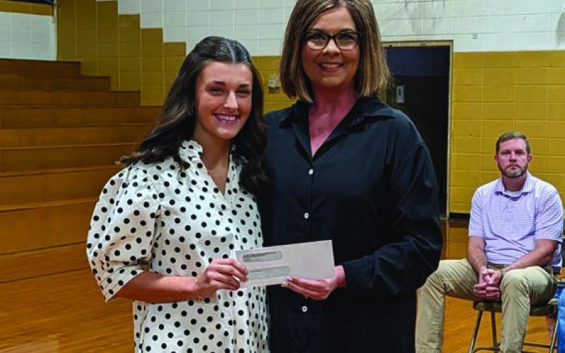 Dr. Kim Turner presents the Arkansas Association of Curriculum and Instruction Administrators Scholarship to Mallory Stuckey