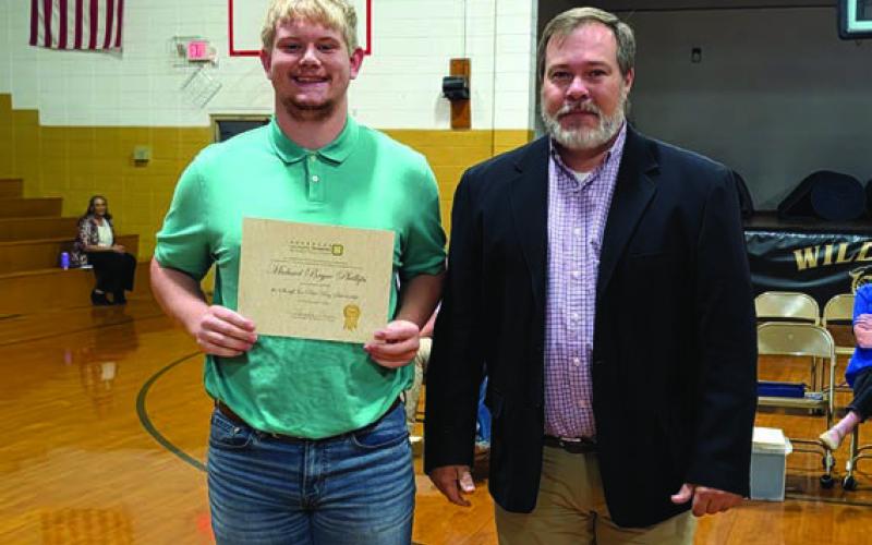 Davy King presents the Sheriff Joe Paul King Memorial Scholarship to Bryce Phillips