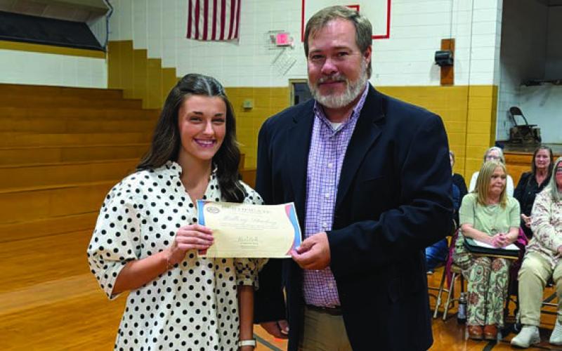 Davy King presents the Arkansas School Plant Management Association Scholarship to Mallory Stuckey