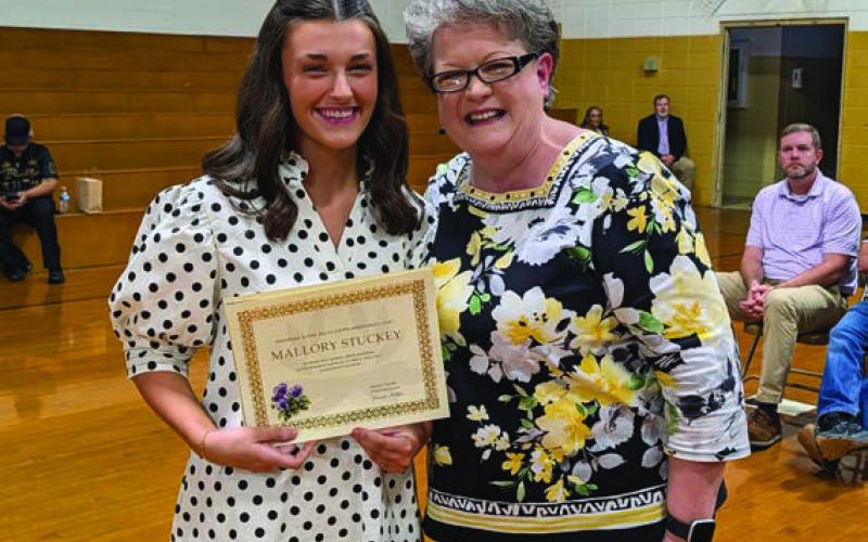 Angelia Crouse presents the Arkansas Alpha Delta Kappa Scholarship to Mallory Stuckey