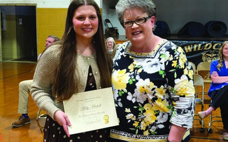 Angelia Crouse presents the Kingsland Alumni Scholarship to Addy Mitchell