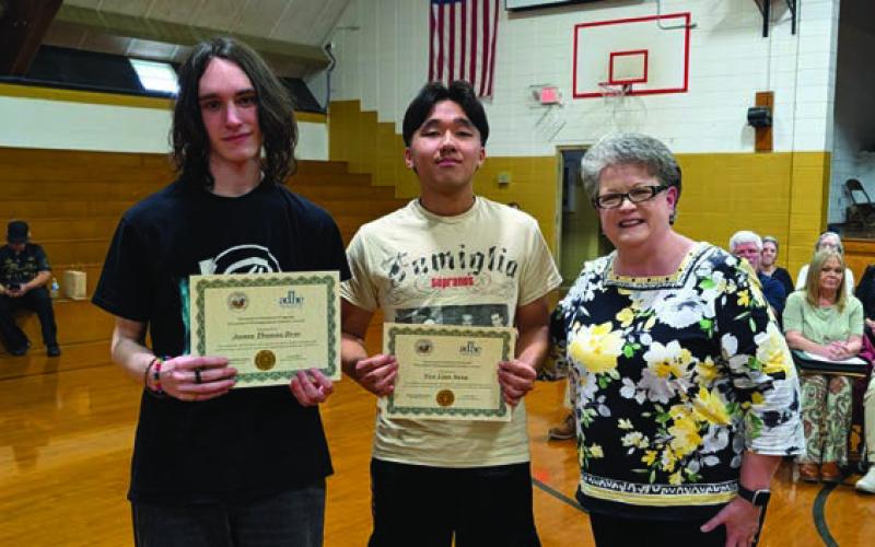 Angelia Crouse (far right) presents the Governor’s Distinguished Scholar Award to James Drye and Van Sang
