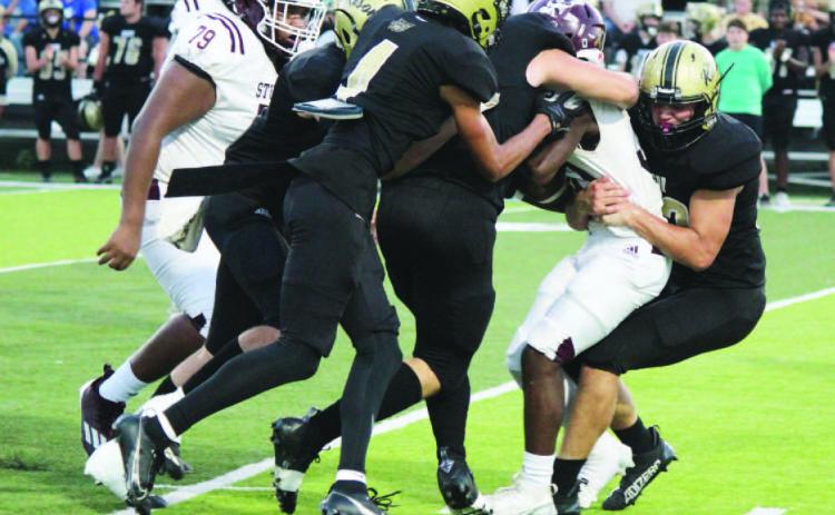STUFFED RICEBIRD - Rison's Eli Turner (right) and Ayden Laws (s econd from right) bring down a Stuttgart Junior Varsity Ricebird for a loss in first half action Tuesday night. Stuttgart struggled to get anything going against the Wildcat defense in the first half as Rison raced out to a 36-0 lead by halftime. Also in on the play the play for Rison are Ethan Saeler (left) and Braylin Bennett (second from left).