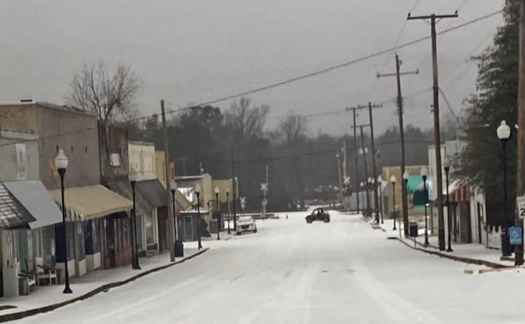 SLOW DAY ON MAIN STREET -  A side-by-side makes a U-turn on an otherwise desolate Main Street in downtown Rison Monday morning. With schools, government offices and banks closed for the Martin Luther King holiday, very few motorist ventured out onto the icy roads.