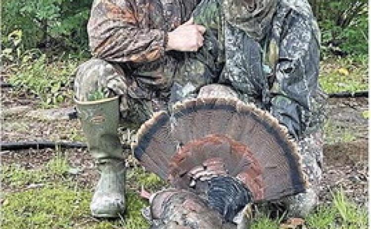 TURKEY HARVEST UP - Brad and Karla Young show off a good Arkansas turkey harvested this season. Arkansas hunters broke 9,000 checked turkeys for the first time since 2017 this year. (Photo courtesy Brad Young)