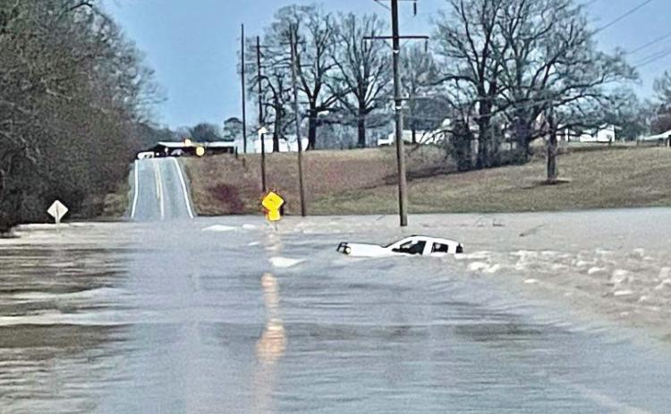 MOTORIST RESCUED - Arkansas Game &amp; Fish Officer Eric Rawls of Rison conducted a boat rescue of a the driver of this pickup truck that was washed off Hwy. 114 just east of the Cleveland-Lincoln County line at Hudgin Creek early Tuesday morning. This was the third rescue of motorists at this same location on Hwy. 114 in the past few years. (Photo courtesy of Eric Rawls)