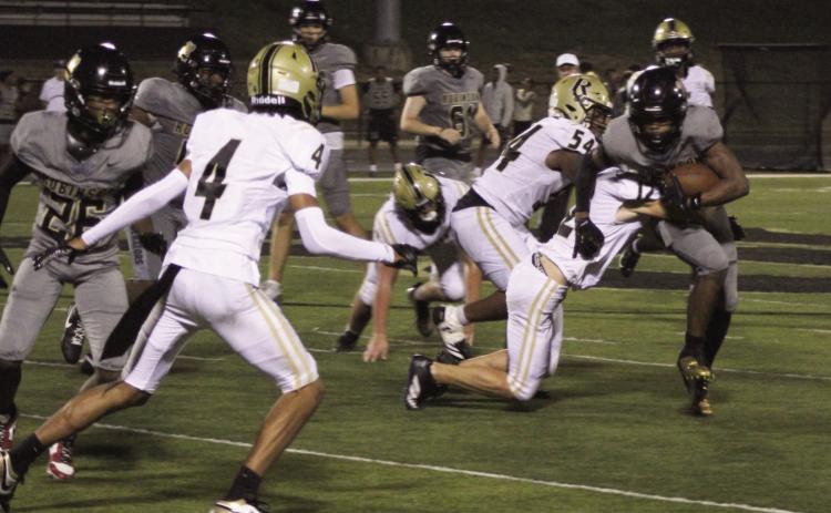 WRAPPING UP A SENATOR - Rison's Dalton Lee (right, 12) wraps up Robinson junior running back Will Moore (right, 24) while the Wildcats' Galvin Wilson, Jr. (54) closes in for an assistt during last Friday night's action at Little Rock. Lee continues to be a force on defense for Rison. After being in on 21 tackles the previous week, he registered 19 against the Senators, including five solos and two pass break-ups. Also pictured for Rison is Braylin Bennett (4).