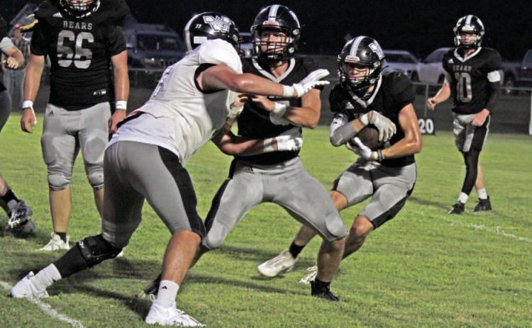 JOHNSON HAS GOOD SCRIMMAGE - Aidan Johnson (second from right) follows the block fullback of Brayden Jones against Brayden Kitchens during last Friday's Black-and-White scrimmage. Johnson, who usually plays tight end, rushed for 116 yards with two touchdowns.