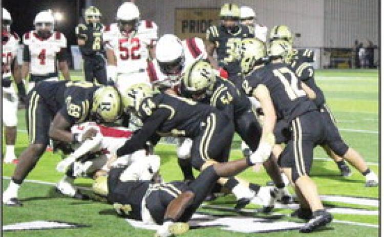 GANG TACKLE - Rison's Kyson Waker (3, bottom) wraps up Fordyce running back Tramane Turner near the line of scrimmage as teammates Javis McGhee (69), Tanner Collins (64), Galvin Wilson, Jr. (54) and Dalton Lee (12) close in to assist. The Wildcats had one of their better defensive performances, holding the Redbugs to 257 yards rushing for the game, 78 of which came on one play. (Photo by Chris Phillips)