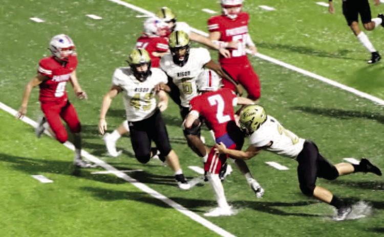 NO WHERE TO GO - Palestine-Wheatley's Easton Vaccaro (no. 2) fin ds himself trapped as Rison's Aaron Tilley (right, no. 21) moves in for the tackle while teammates Bryce Phillips (no. 43) and Jaquis Rauls (no. 6) close in on the play. The Wildcats defense held the Patriots to just two first downs in the game. (Photo by Chris Phillips)