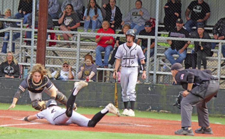 CRUCIAL PLAY AT THE PLATE - Rison catcher James Jacobs lunges toward home plate to make a play on Woodlawn's Austin Howard as he attempts to steal home in the top of the fourth inning. Howard made his move as the Wildcats made a throw to first, but an alert Rison first baseman Jared Saeler made the throw back home to get the call for the third out. Woodlawn's Dylan Butler is in the background. Howard's run would have given the Bears the lead after Tate Hall had driven in the tying run to make it 2-2.