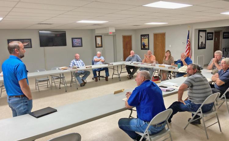 NEW SOLID WASTE CONTRACTOR MEETS QUORUM COURT - Jaylan Smith (left), co-owner of Big Smith Waste Services based in Lincoln County, addresses the Cleveland County Quorum Court after it had accepted his company’s bid to enter into a five-year contract with the county for solid waste disposal services. The new contract begins on Jan. 1, 2023. Tuesday’s quorum court meeting was moved to the Hall-Morgan Veterans Building in Rison to make it easier for County Judge Melody Spears (pictured near the center of the l